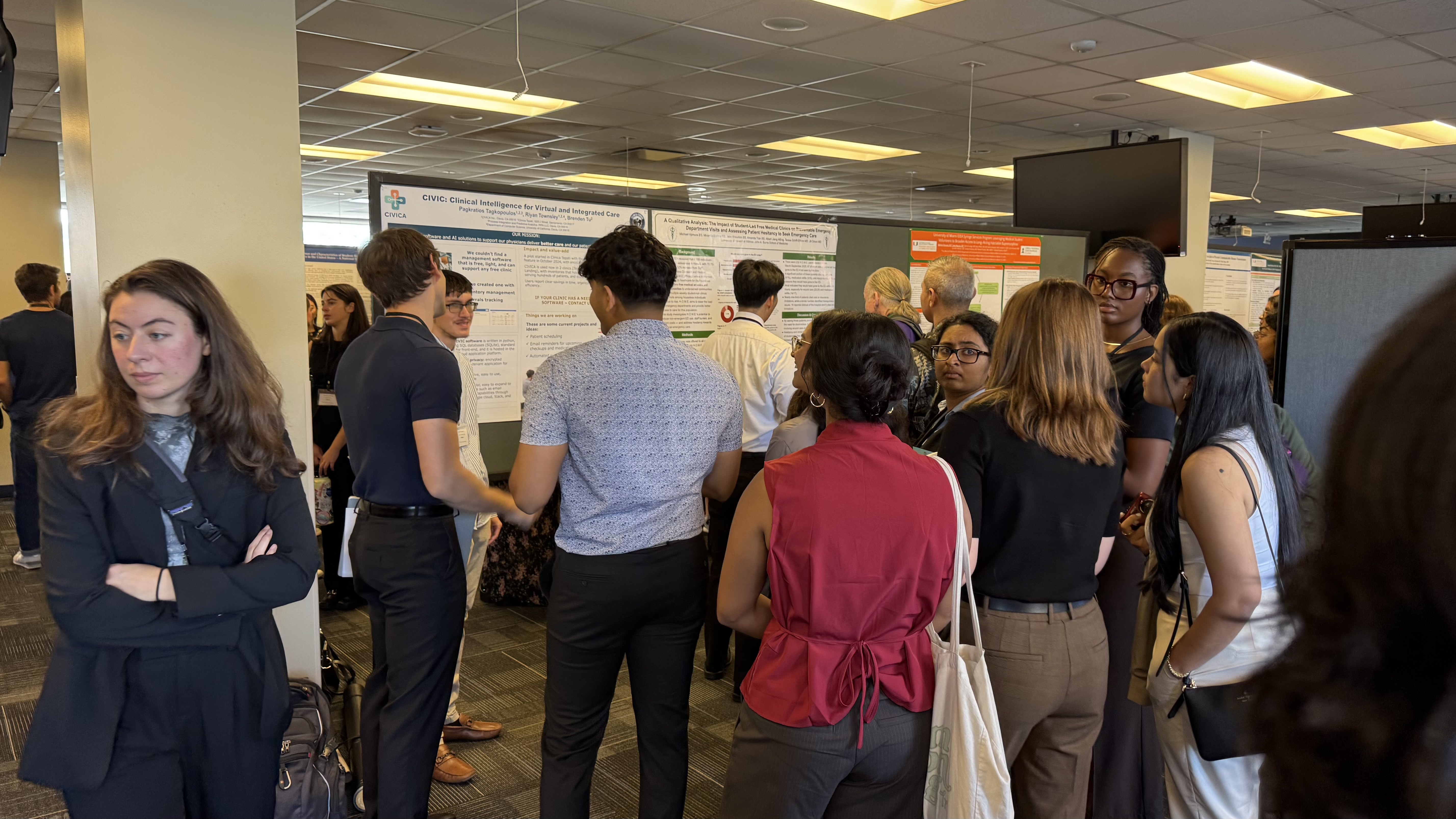 Crowded poster session at the SSRFC 2025 conference, with attendees gathered around the CIVIC research poster
