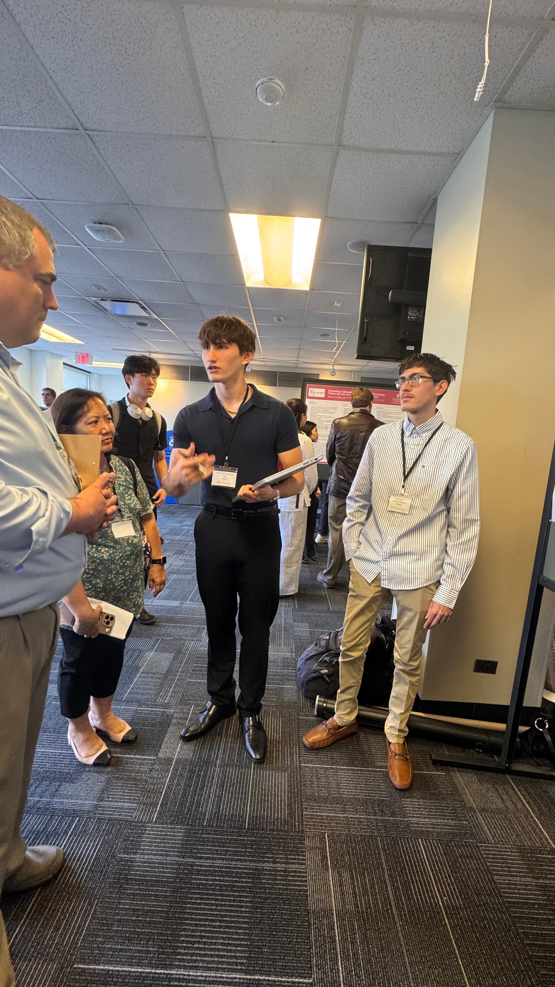Pagkratios presenting the CIVIC platform to conference attendees while Riyan stands nearby